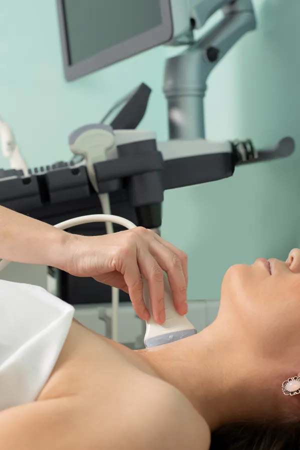 Hashimotos-Thyroiditis-Treatment A woman gets a thyroid scan from a doctor in a clinic. Get help with Hashimoto's Thyroiditis from Dr. Noelani Rodriguez in San Diego.