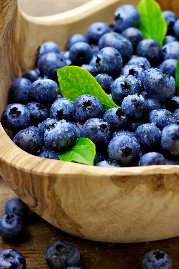 IV-Therapy-Treatment A bowl of refreshing, nourishing blueberries in a wooden bowl, representing IV therapy from Dr. Noelani Rodriguez in San Diego.