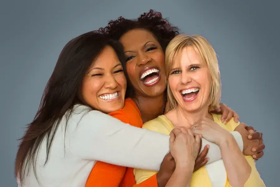Insulin-Resistance-Clinic An asian, black, and white woman of middle age hug and laugh. Get insulin resistance treatment from Dr. Noelani Rodriguez in San Diego.