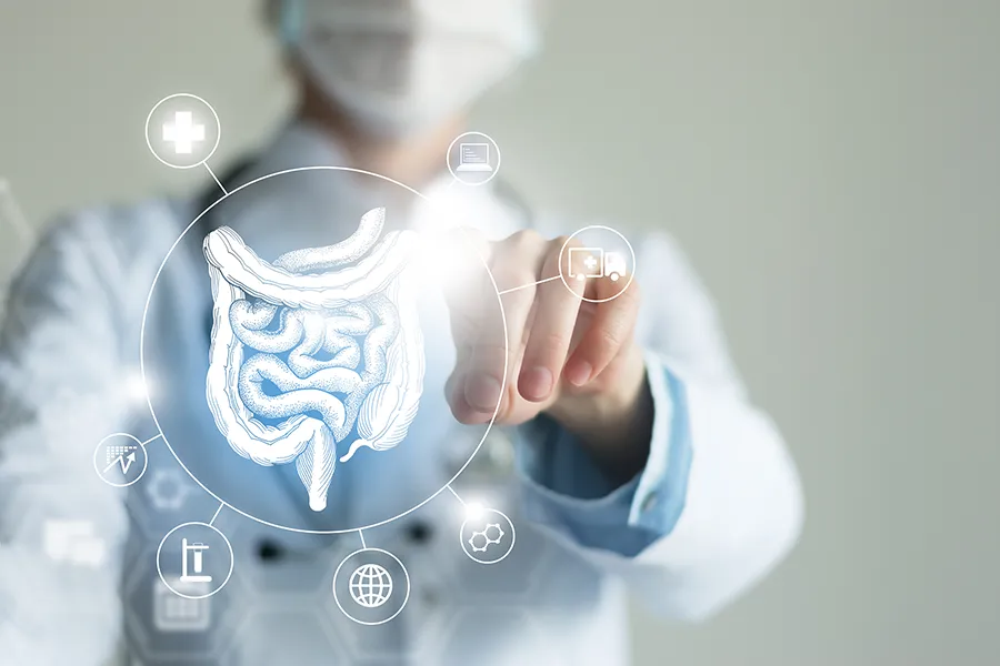 Leaky-Gut-Syndrome-Clinic Dr. Noelani Rodriguez provides advanced Functional Medicine for Leaky Gut Syndrome treatments in San Diego, shown by a doctor touching a glowing digital intestinal health display.
