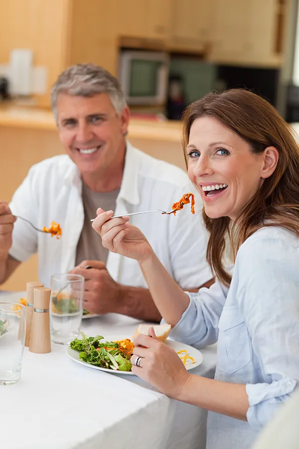 Leaky-Gut-Syndrome-Treatment Improve digestion with Dr. Noelani Rodriguez's Functional Medicine for Leaky Gut Syndrome care in San Diego, featuring a happy couple enjoying a nutritious lunch at home.