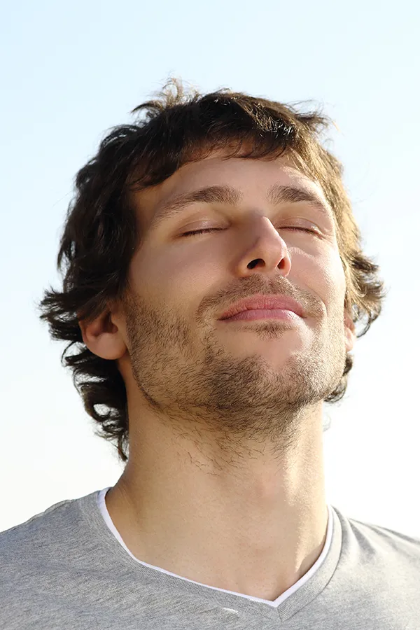 Lupus-Treatment A brown-haired man closes his eyes and breathes in fresh air with his face turned up to the sky. Get treatment for Lupus from Dr. Noelani Rodriguez in San Diego.