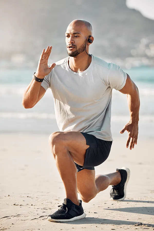MCL-Tears-Treatment A man does lunges on the beach. Get treatment for MCL tears from Dr. Noelani Rodriguez in San Diego.