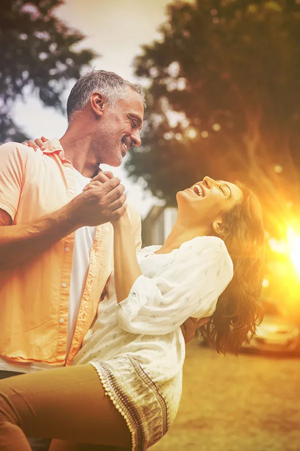 Sciatica-Treatment A couple dances outside in the sunset. Get sciatica treatment from Dr. Noelani Rodriguez in San Diego.