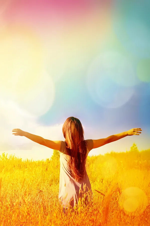 Tennis-Elbow-Treatment A woman stands in a field with her arms outstretched. Get tennis elbow treatment from Dr. Noelani Rodriguez in San Diego.